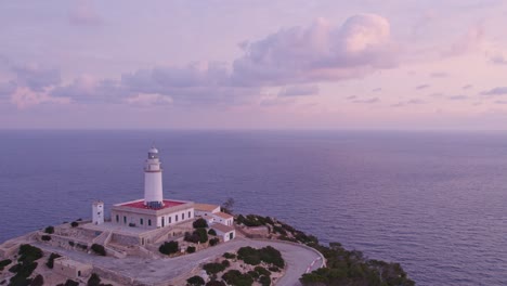 Aerial-view-Cap-de-Formentor-Lighthouse-with-dramatic-cliffs,-mountains-and-rock-formations-by-sunrise