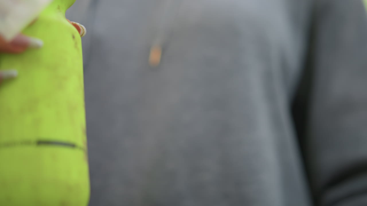 Careful Grip On Bottle, Gentle Twist Secures Bottle Cap, Person Carefully Twists Bottle Cap With Visible Droplet, Individual Firmly Holds And Twists Bottle Cap With Droplet Visible