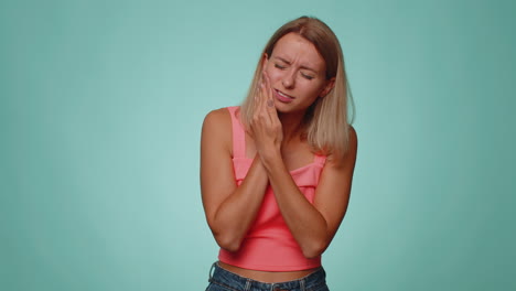 Woman-touching-cheek-suffering-from-toothache-cavities-or-gingivitis-waiting-for-dentist-appointment