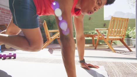 Fit-african-american-man-exercises-with-his-front-support-at-home