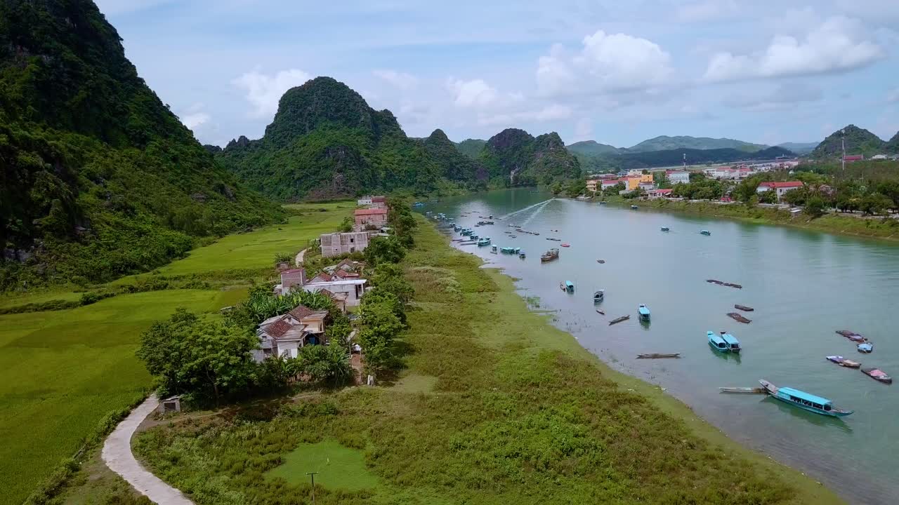 A busy river with fisher boats in Vietnam in picturesque landscape