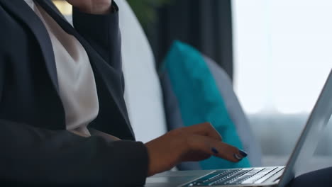 Business-Woman-In-Stylish-Clothes-Talking-On-The-Phone-While-Using-Computer-In-Hotel-Hall