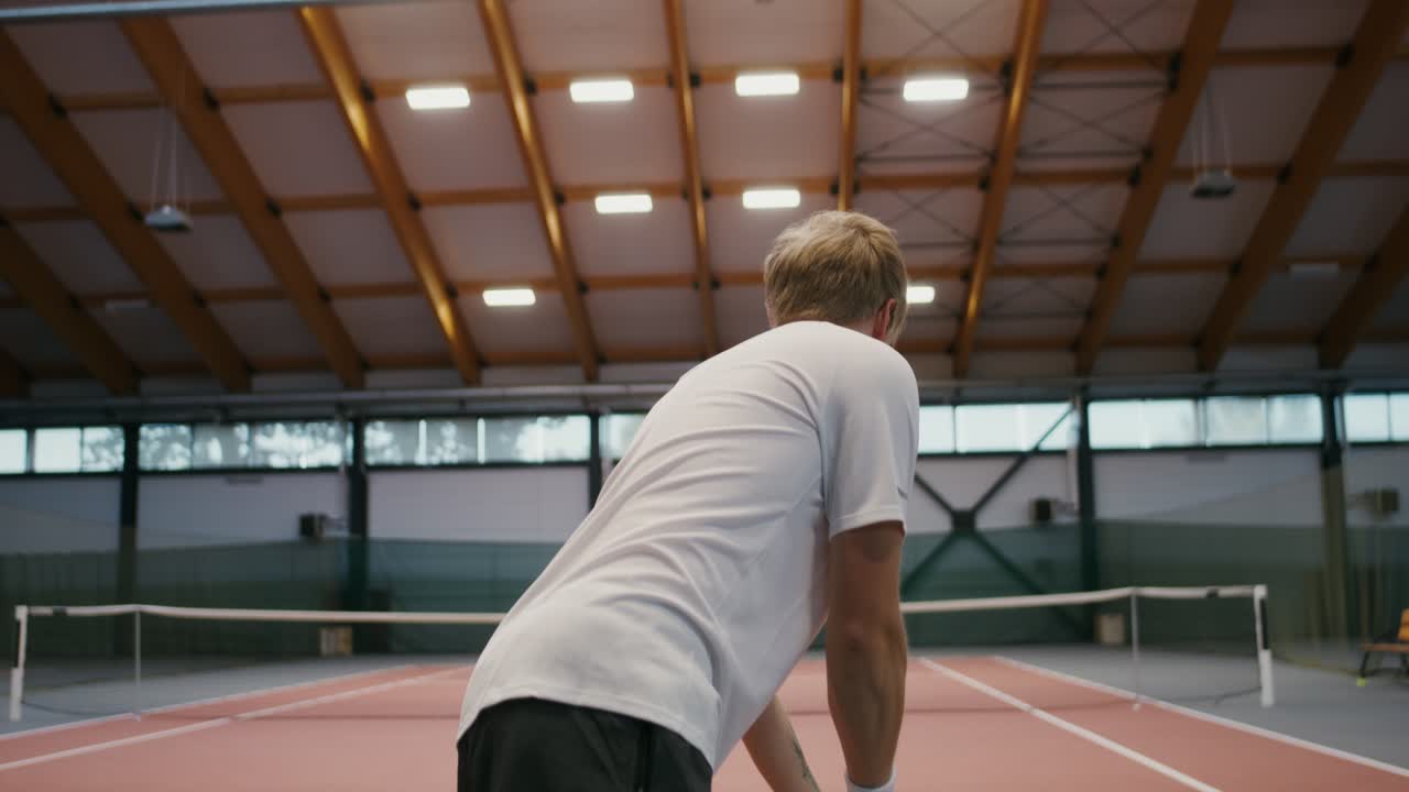 Man Playing Tennis in Indoor Court
