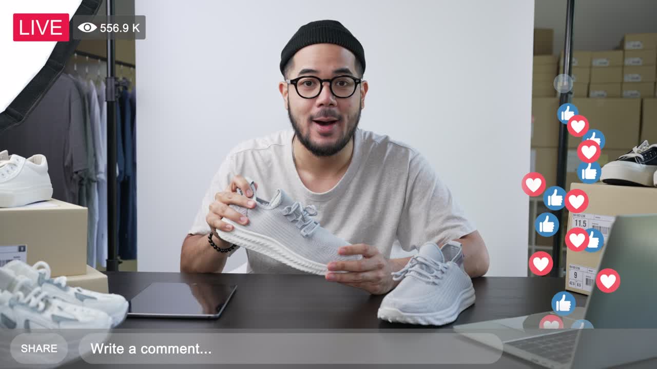 Young attractive Asian man blogger or vlogger looking at camera reviewing product and merchandise. Business online influencer on social media concept.
