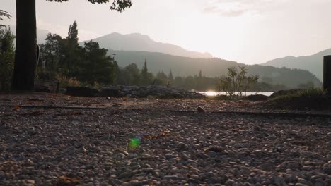 trekking lakeside, morning mountain panorama, sunrise, shiny water of lake garda