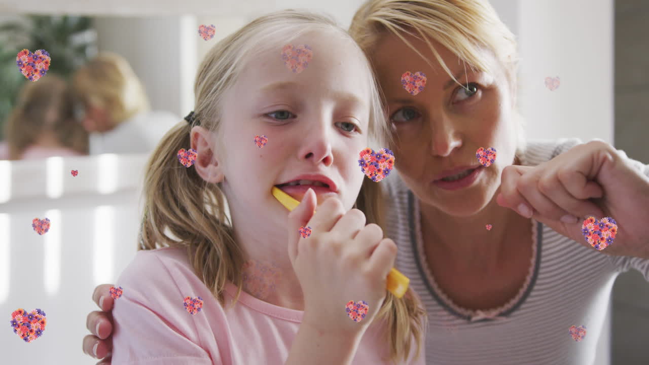 백인 어머니와 딸이 치아를  ⁇ 는 꽃의 심장의 애니메이션