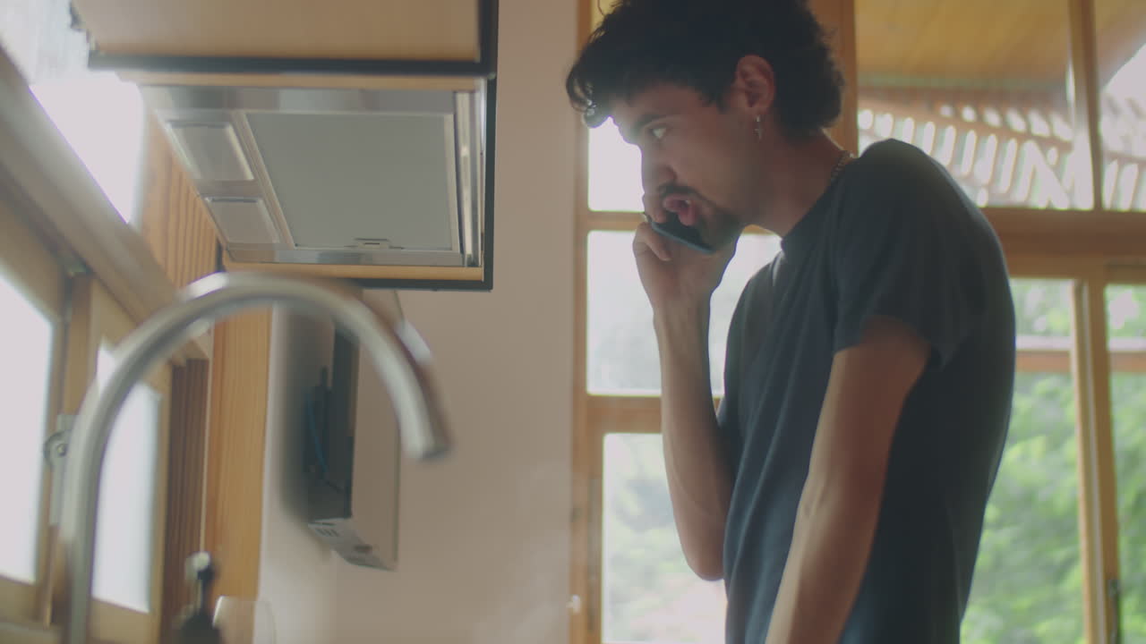 Man Talking on Phone while Cooking Dinner