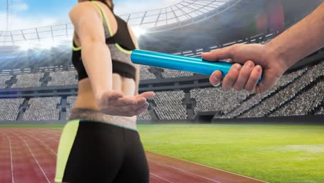 Animation of athlete&#039;s hands passing relay baton over sports stadium