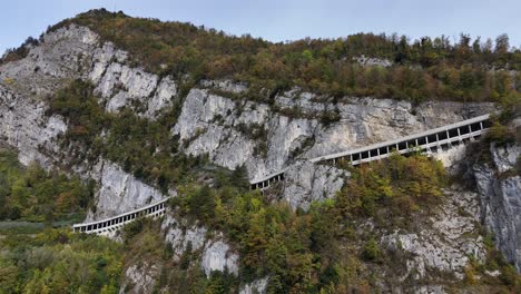 aerial view of historic path at steep rocky mountains in switzerland during cloudy day