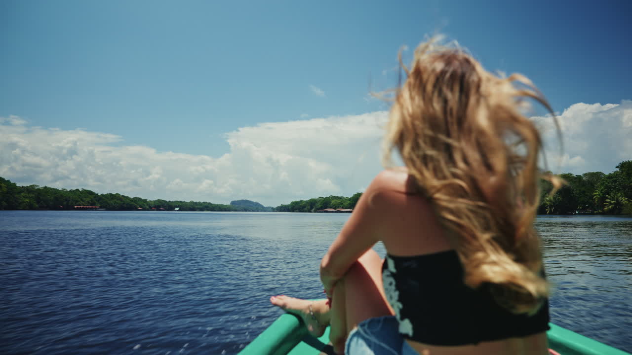 Woman Relaxing on a Boat in a Tropical River