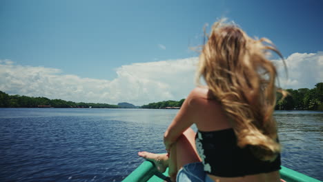 woman relaxing on a boat in a tropical river