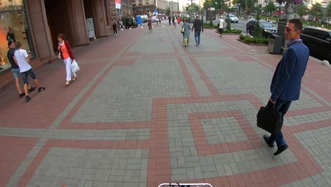 city street scene with people walking and dining