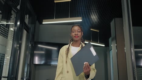 attractive black woman office worker portrait in modern building confident african lady