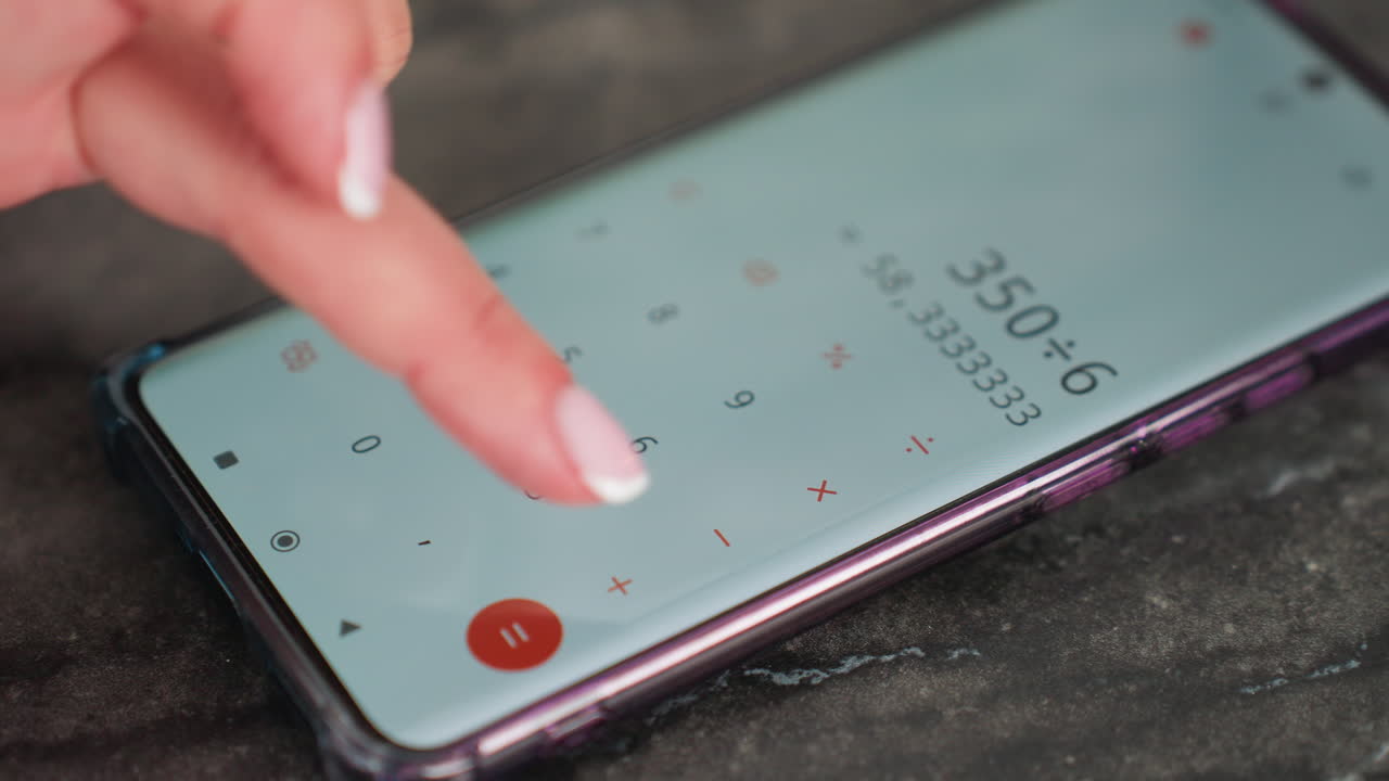 Close up of lady with polished nails using calculator app on smartphone placed on dark table surface, finger tapping screen while performing calculation, focused on solving math problem
