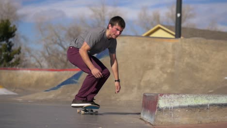 person does a skateboard grind on the ledge