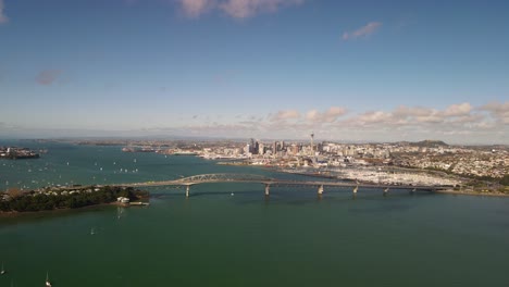 aerial high rise fly to massive construction of auckland harbour bridge