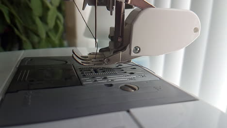 slow motion close up of sewing machine needle