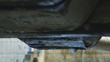 oil dripping from oil pan of a machine