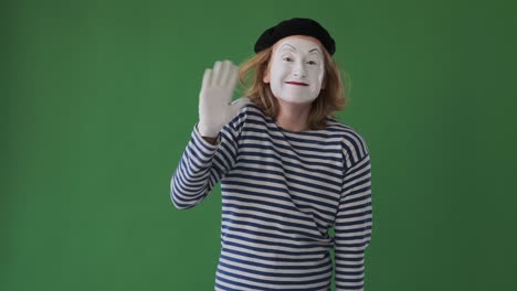 mime man waving hand over green background