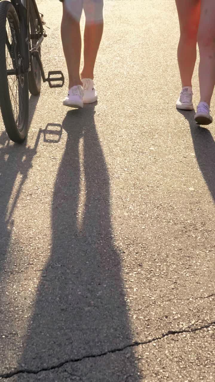 People walking on a path with a bike