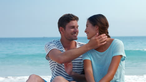 Pretty-couple-looking-at-each-other-at-the-beach-