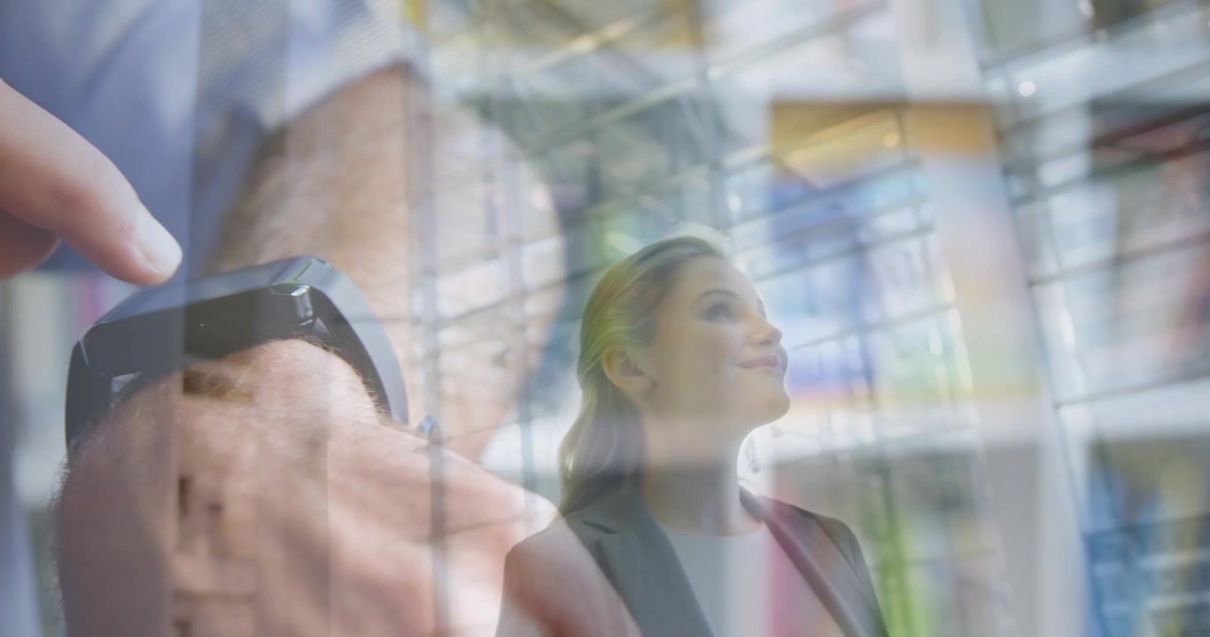 Double Exposure of Businesswoman and Man Using Smartwatch