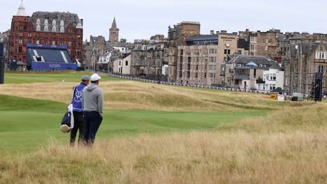 two golfers walking on st andrews golf course