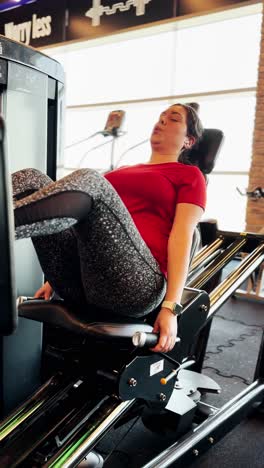 woman performing leg press exercise at the gym