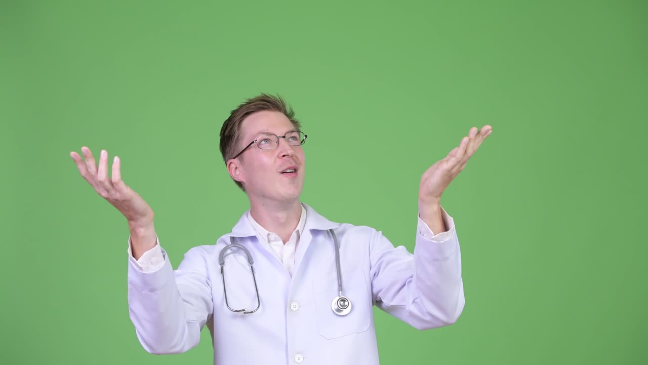 Young Man Doctor Showing Copyspace