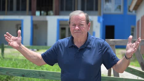 elderly man expresses concern near house under construction