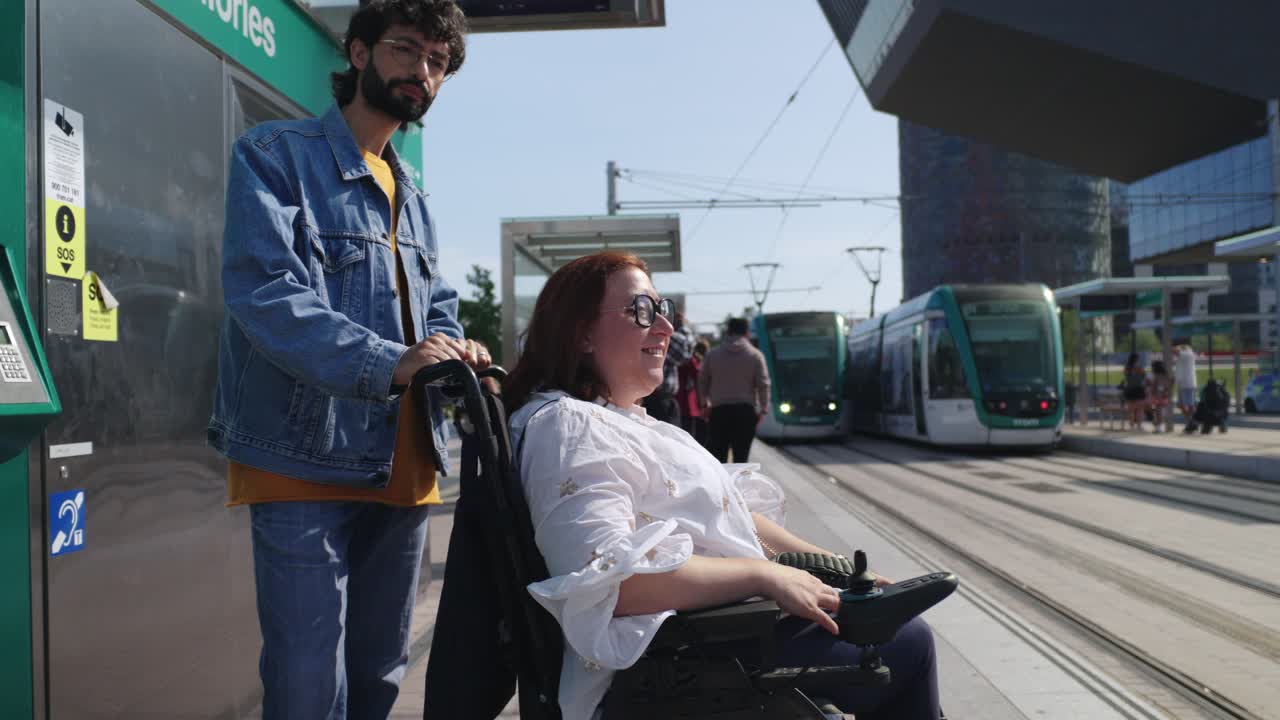 A woman in a wheelchair using public transportation with assistance