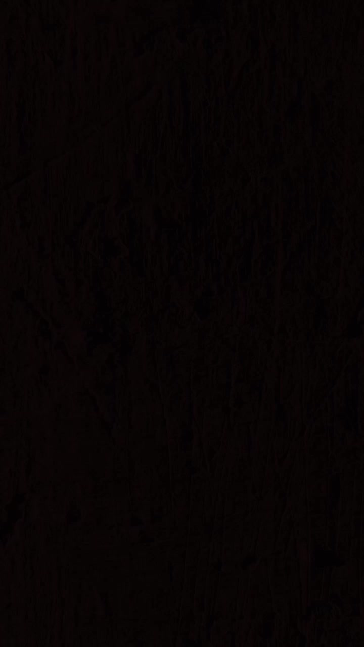 Flashing police car lights reflecting on a dark, rough wall, creating a moody and tense background for crime-related content