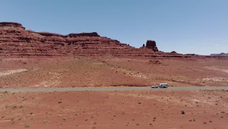 car with a trailer driving over the state route 95, hite, utah