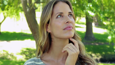 thoughtful woman in a park