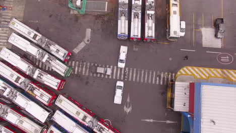 Overhead-of-three-cars-parked-in-the-center-of-a-bus-station
