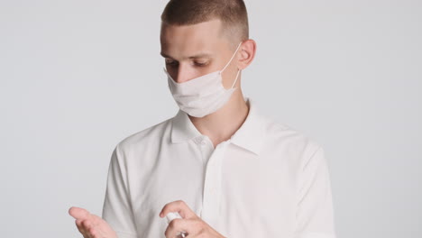 blond man with face mask, washing his hands