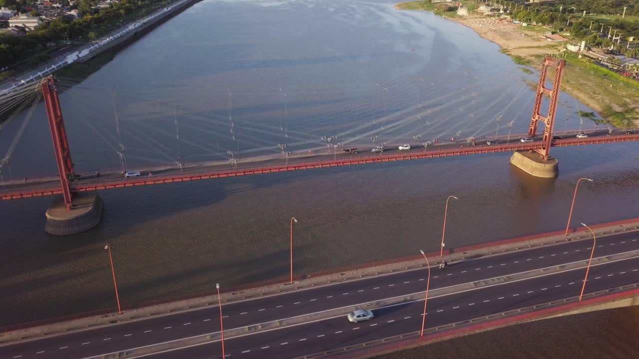 Aerial View of a Red Suspension Bridge over a River