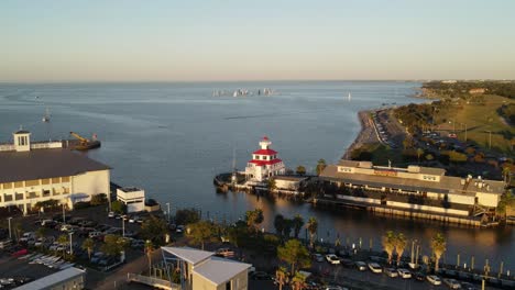 Aerial View of a Lighthouse and Marina at Sunset