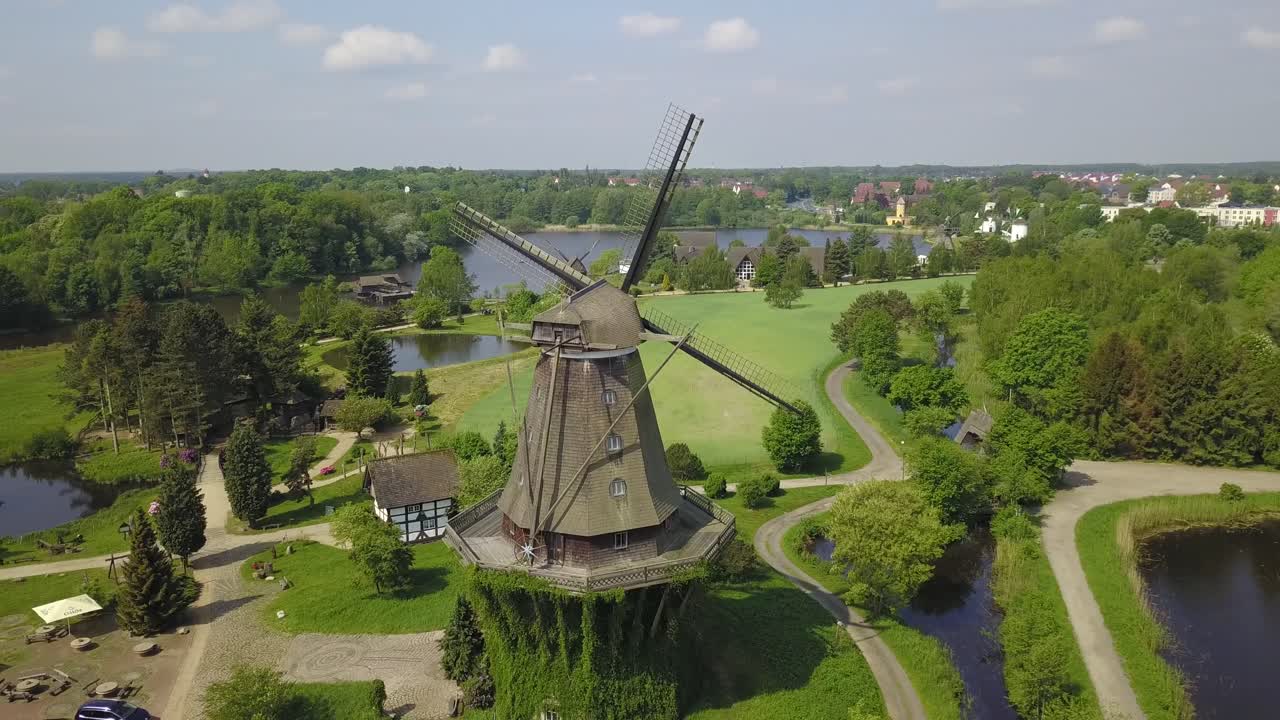 A stunning aerial perspective of a windmill, highlighting its symmetrical design and perfect integration into the museum landscape.