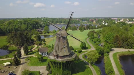 a stunning aerial perspective of a windmill, highlighting its symmetrical design and perfect integration into the museum landscape.