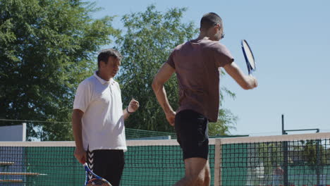 tennis coach and player on court