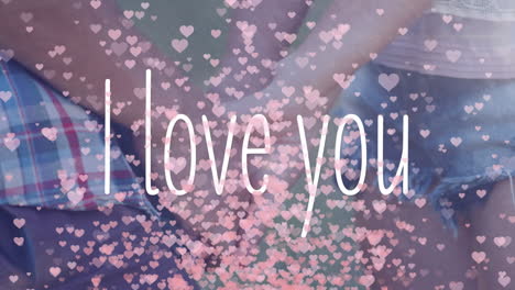 배경에서 손을 잡고 있는 사람들과 함께 "i love you"의 애니메이션