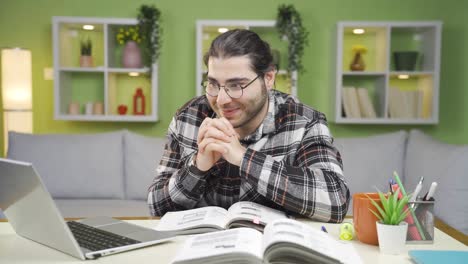 Young-man-focusing-on-laptop-impatiently-and-excited.