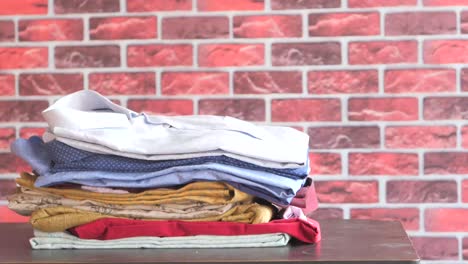 a stack of folded clothes on a table