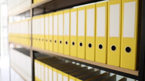 yellow binders on a shelf
