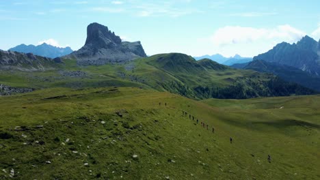 stunning tracking shot of athletes running over green mountains