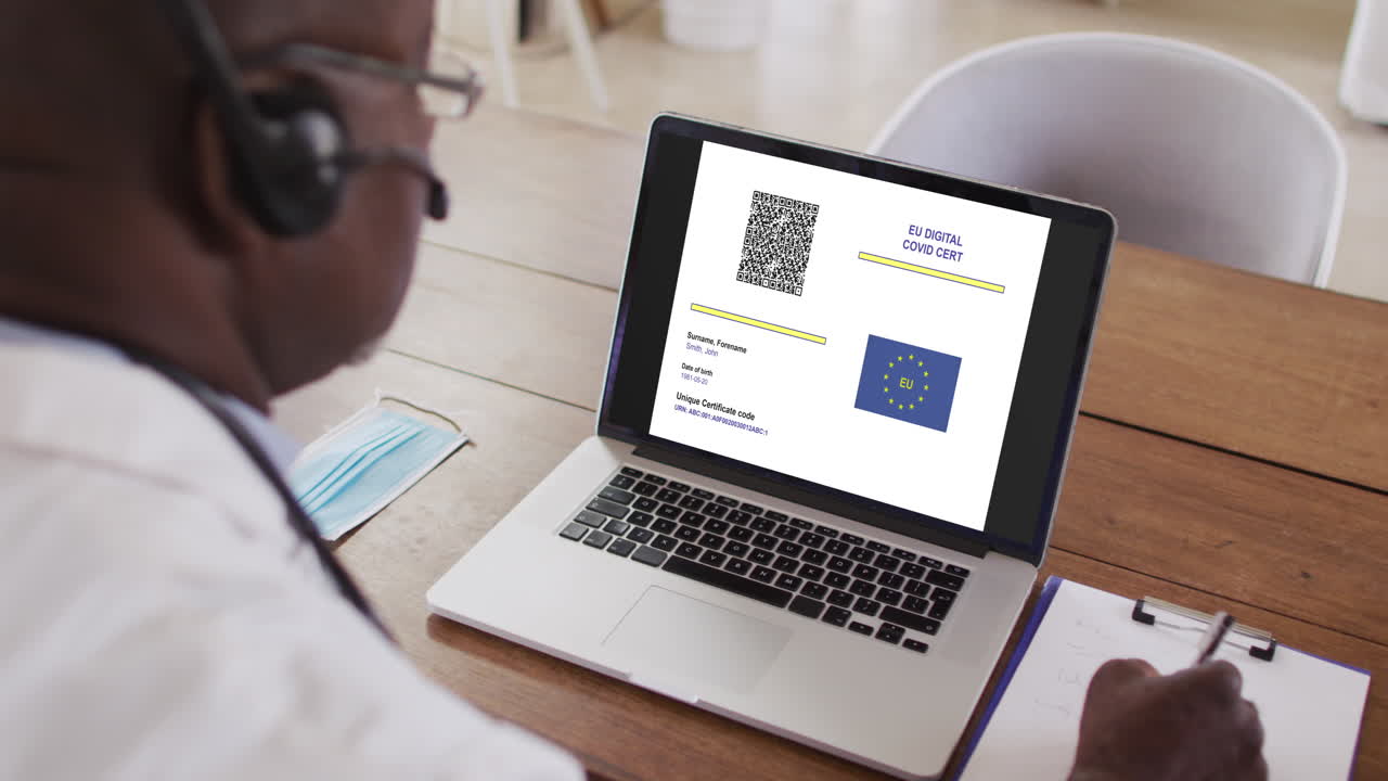 Man working at desk, covid vaccination certificate with qr code and eu flag on laptop screen