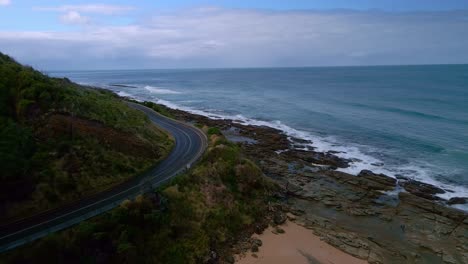 Empty-Great-Ocean-Road-coastal-highway-corner-with-no-traffic,-Victoria,-Australia