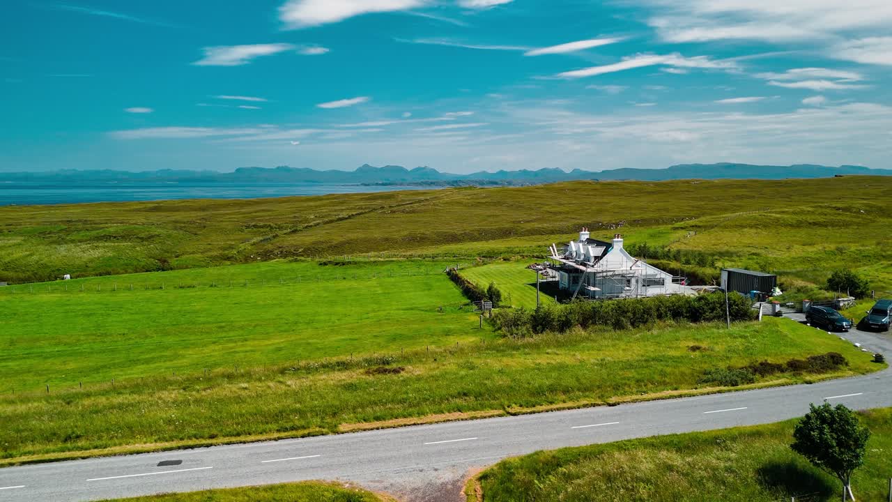 Aerial view of a house in a green field
