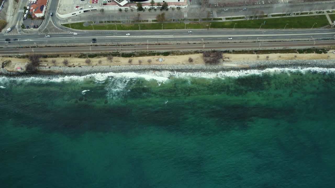 Aerial view of coastal city with highway and ocean